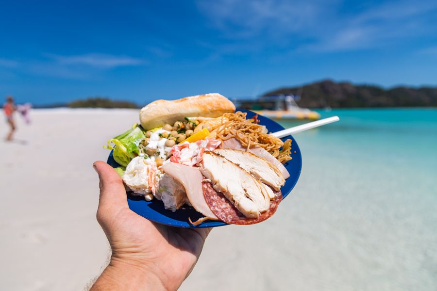 Salad and meat plate held on Whitehaven Beach, Whitsunday Island