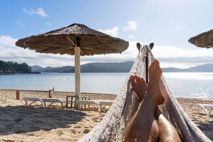 person lounging in a hammock at hamilton island