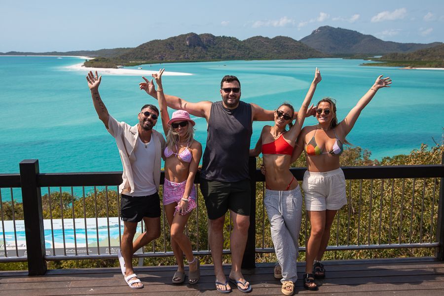 travellers posing at hill inlet lookout whitehaven beach