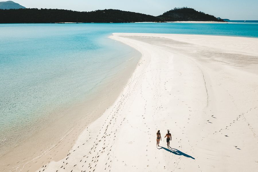 Whitehaven Beach Couple couple strolling on white sands of whitehaven beach