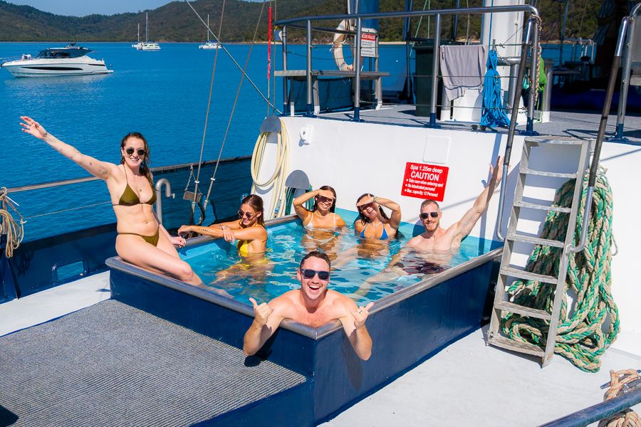 people posing in heated spa onboard atlantic clipper