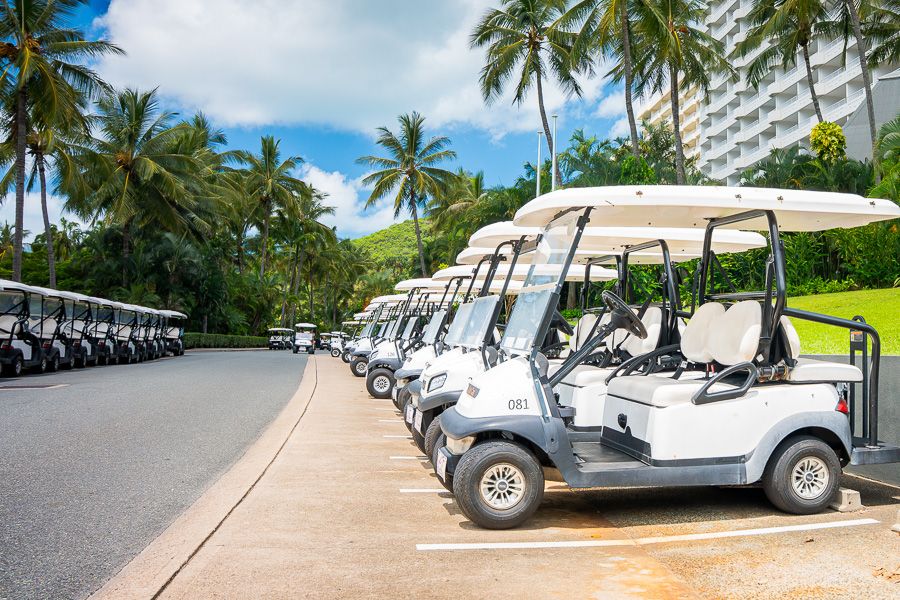 a row of golf buggies lined up