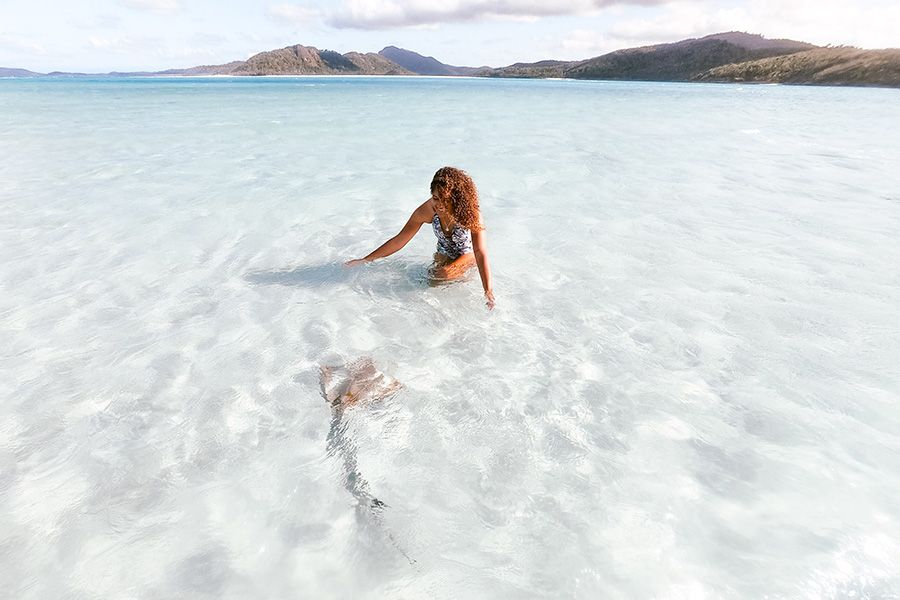 Girl and stingray at Whitehaven, Whitsundays, Australia