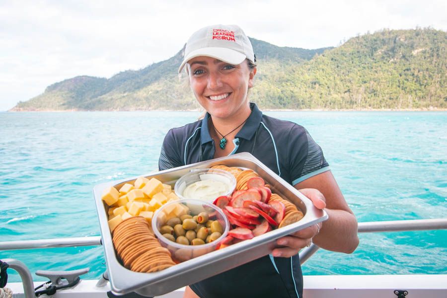 Whitsunday hosty with platter of food on a boat