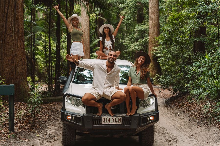 traveller smiling in the forest on a 4WD Kgari