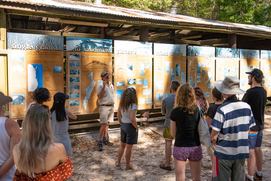 local guide giving a presentation to a tour group on k'gari