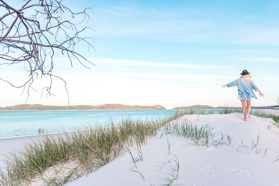 girl walking on the white sands of Whitehaven Beach