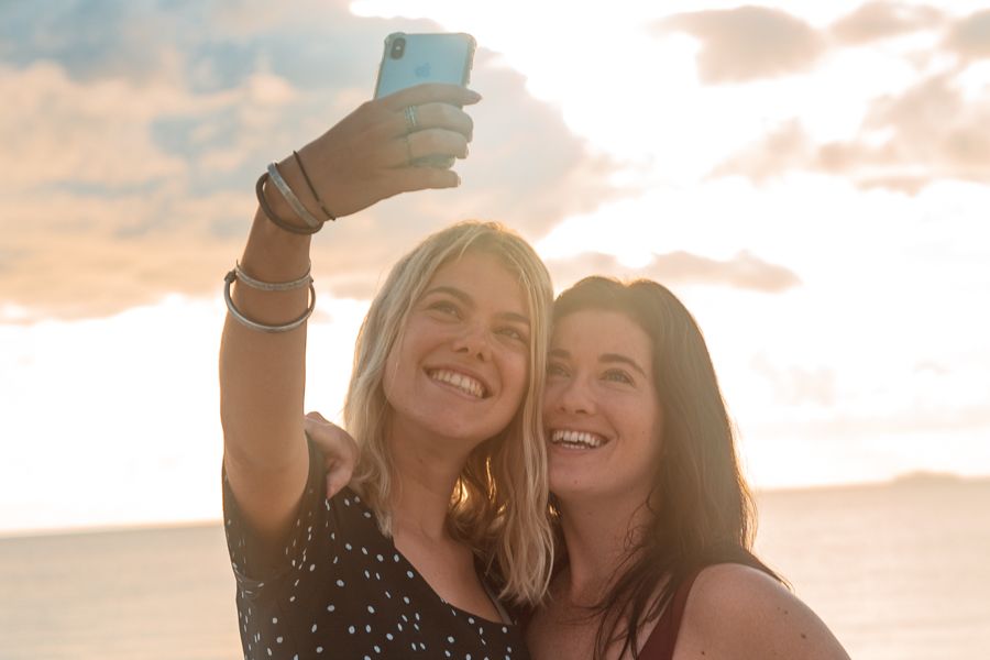 Girls taking selfies on the beach on Kgari Fraser Island