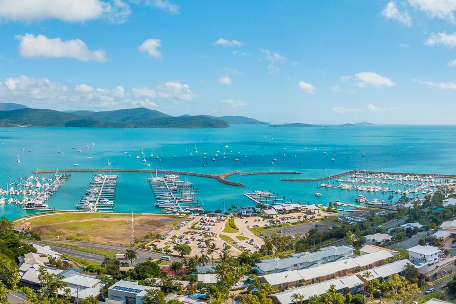 A birds eye view of a marina filled with sailing boats and yachts