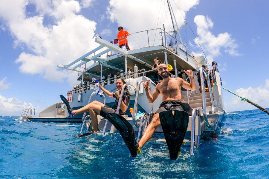 Couple in a boat ready for snorkelling, Cairns, Queensland, Australia