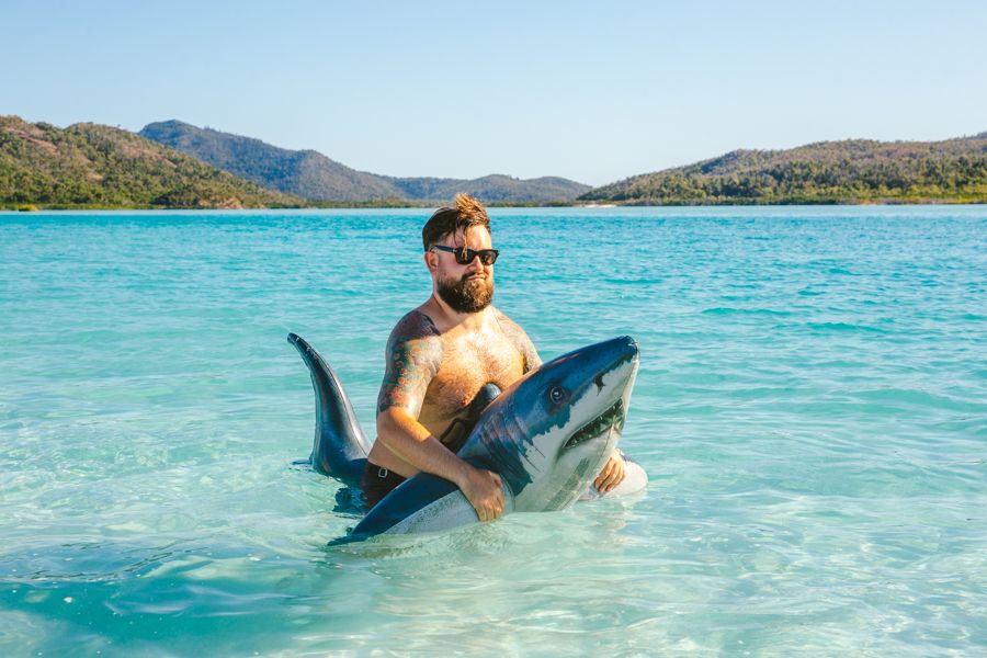 Guy in a shark floaty, Whitehaven Beach, Whitsundays, Australia