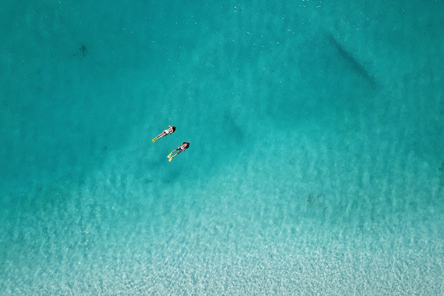 Two girls snorkelling in Whitehaven Beach, Whitsundays, Australia