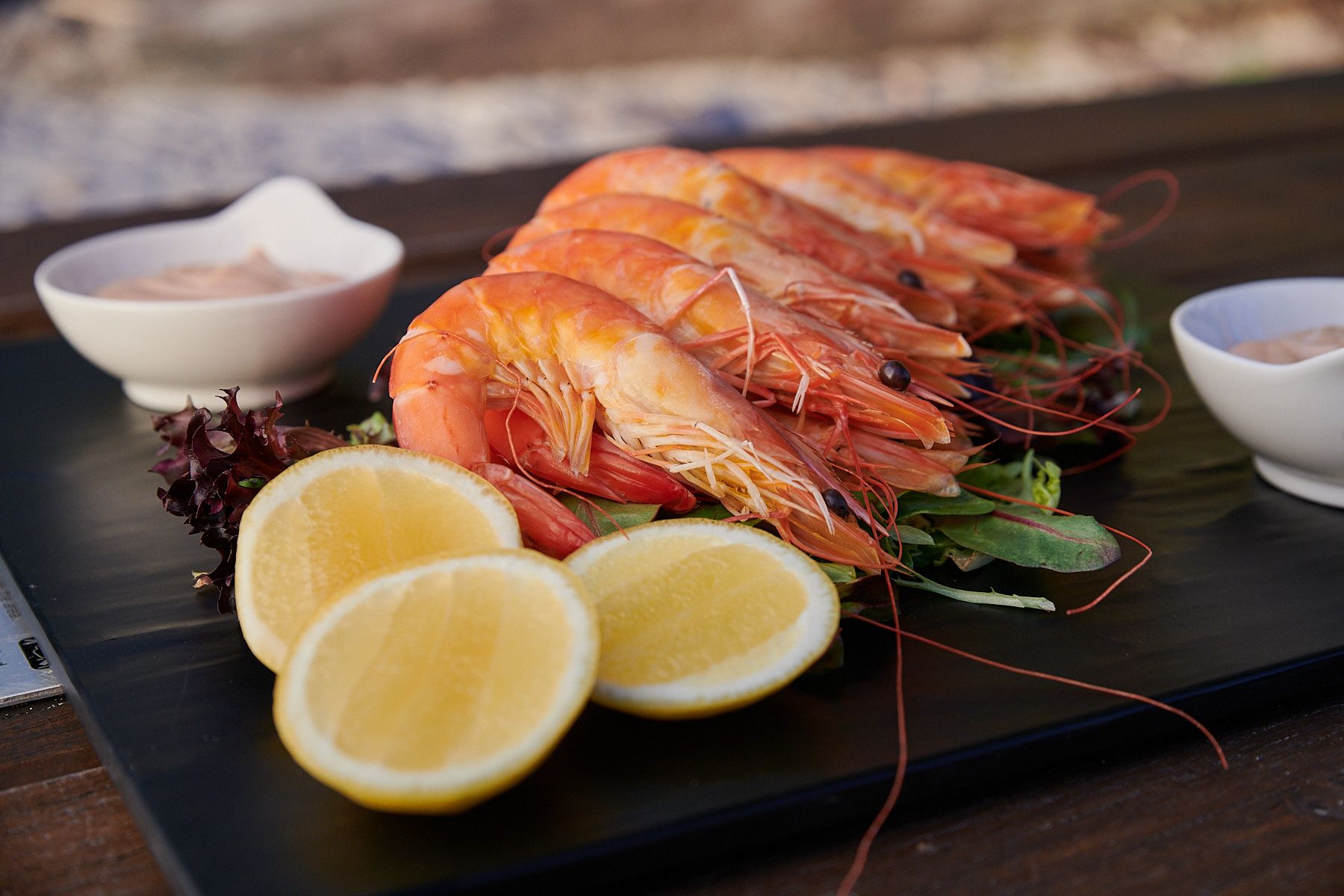 prawns and lemons on a plate at kingfisher bay dune restaurant