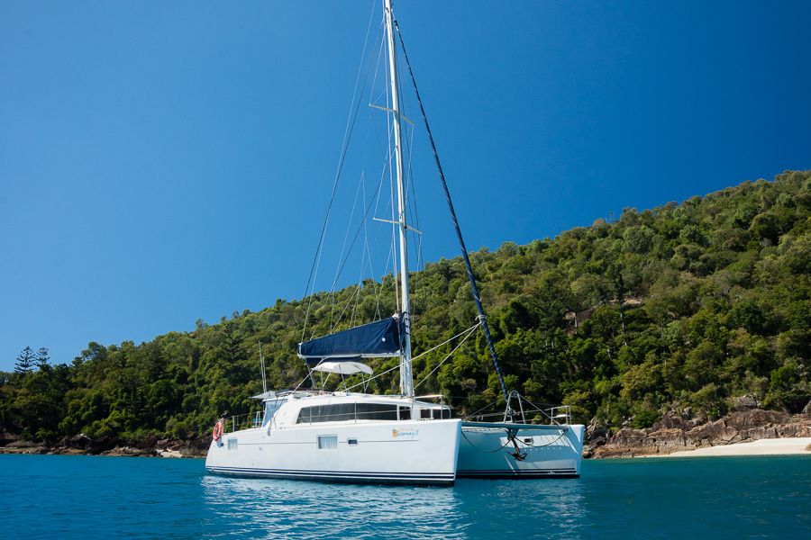 a drone shot of a catamaran at anchor