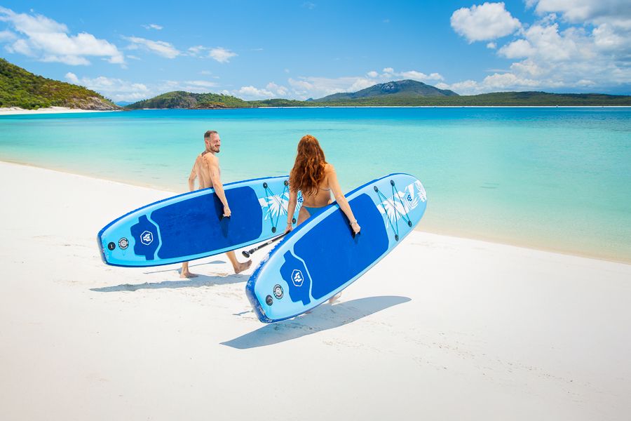 travellers with paddleboards in the whitsunday islands