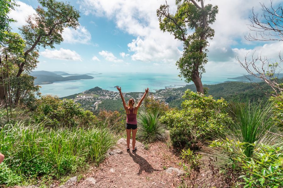 Women throwing her hands in the air at Honeyeater Lookout, Airlie Beach