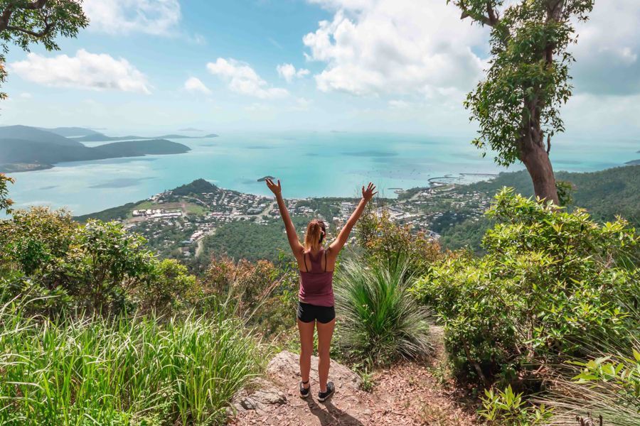 Honeyeater Lookout with woman standing with her arms out looking at the water 