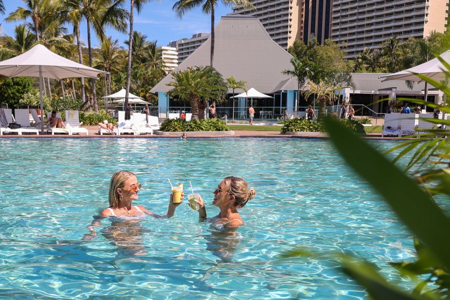 Two women holding cocktail in the pool, Hamilton Island