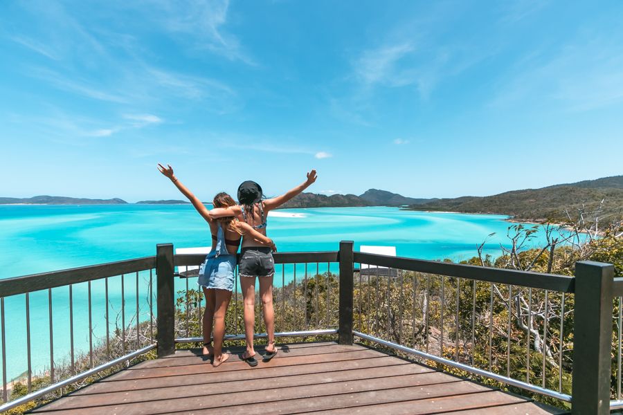 Two people with their hands up in the air, Hill Inlet Lookout