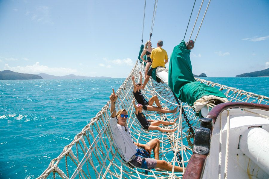 People relaxing in Solway Lass's front nets, Whitsundays