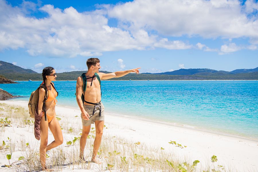 couple walking on chalkies beach whitsundays