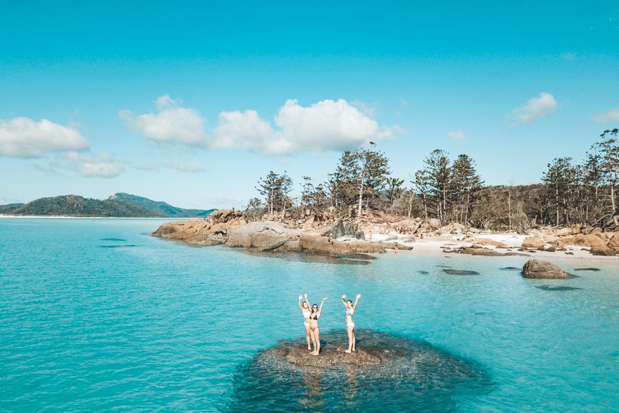 Three people swimming off Whitehaven Beach, Whitsundays