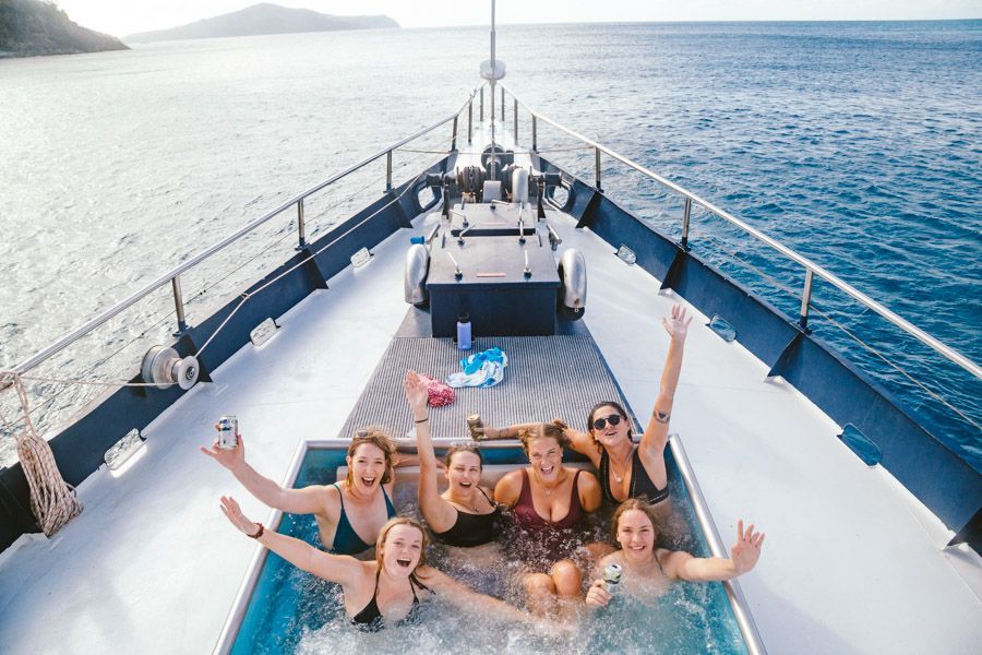 Bunch of friends relaxing in the onboard jacuzzi, Atlantic Clipper, Whitsundays