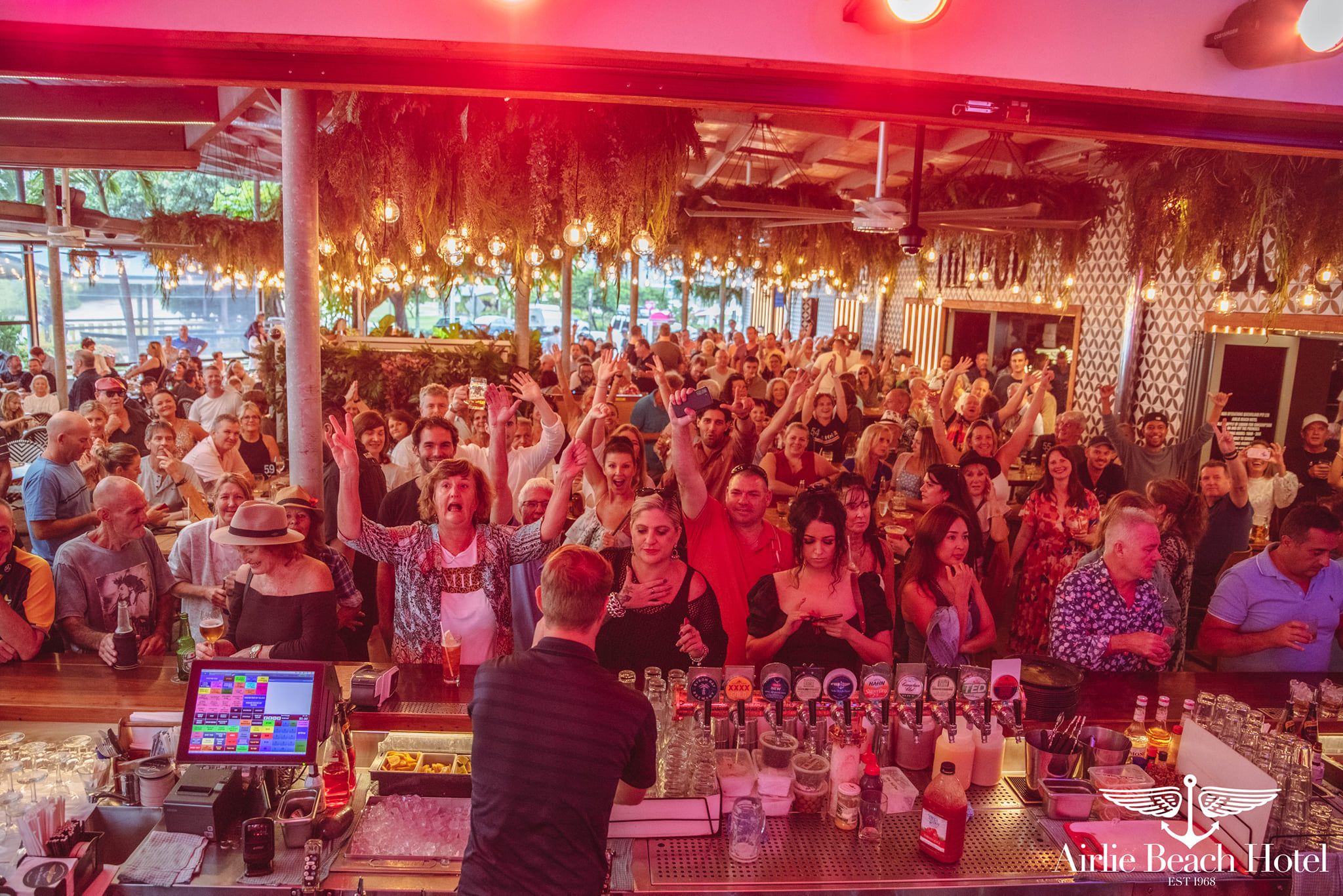 A crowd of people watching a band performing 