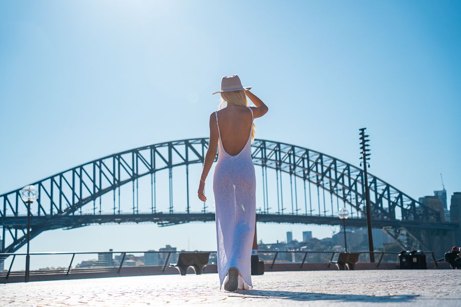 Sydney Harbour Bridge with woman in a low back white dress