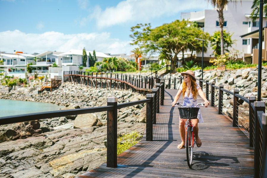 Person riding their bike along the Bicentennial Walkway, Airlie Beach.