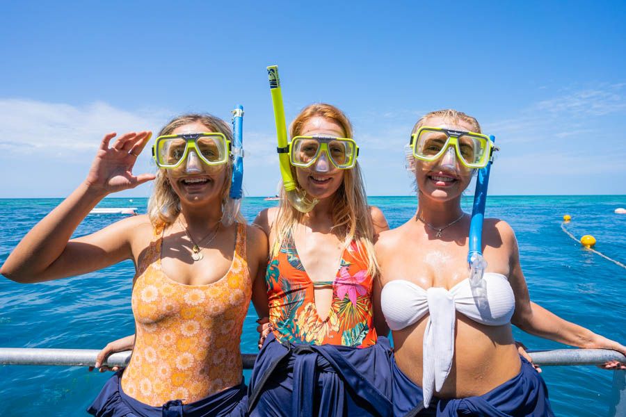 Three women wearing snorkel masks at Reefworld, Outer Great Barrier Reef