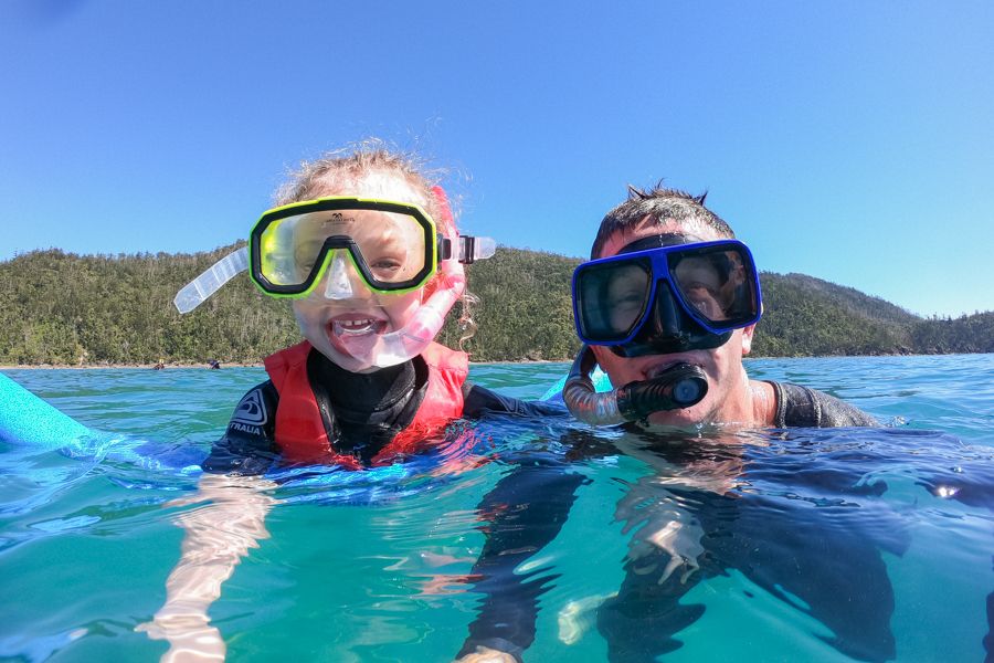 Child and father snorkelling in the Whitsundays