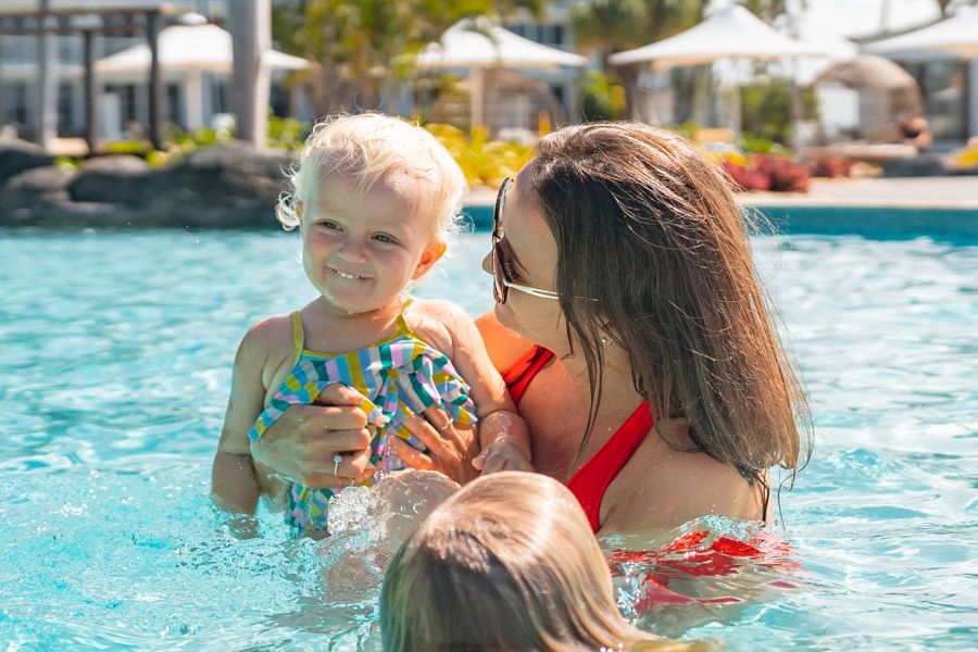 Mother and daughter in the pool smiling at Hamilton island