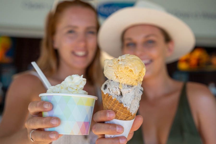 Two Women holding ice creams, one in a cone, one in a cup