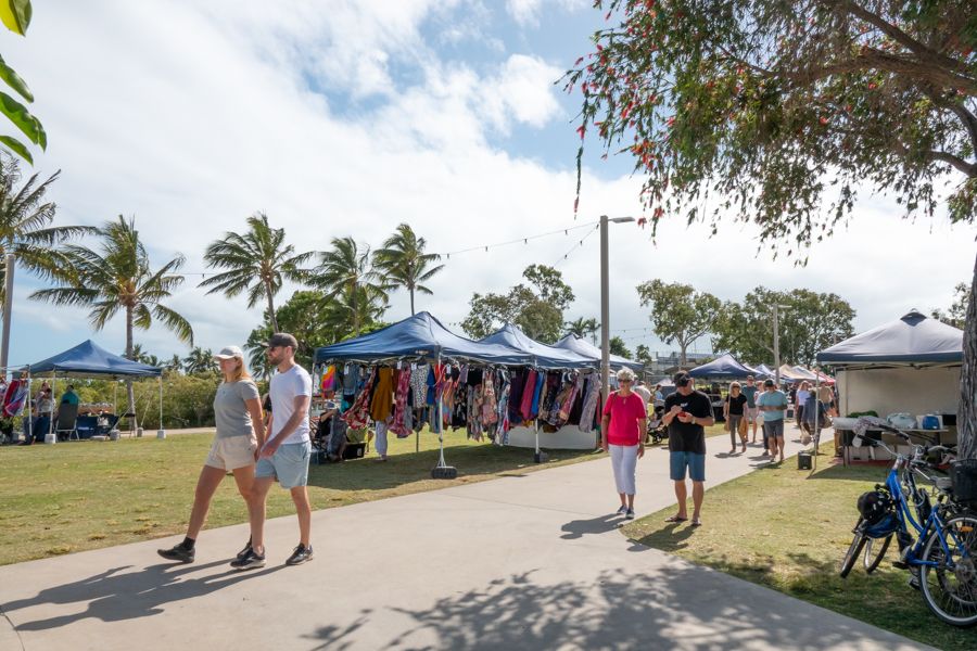 People walking through market stalls