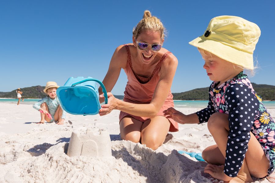 Family making sandcastles at the beach