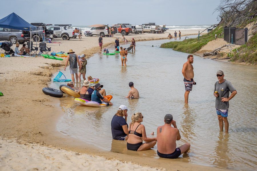 people relaxing in a creek on fraser island