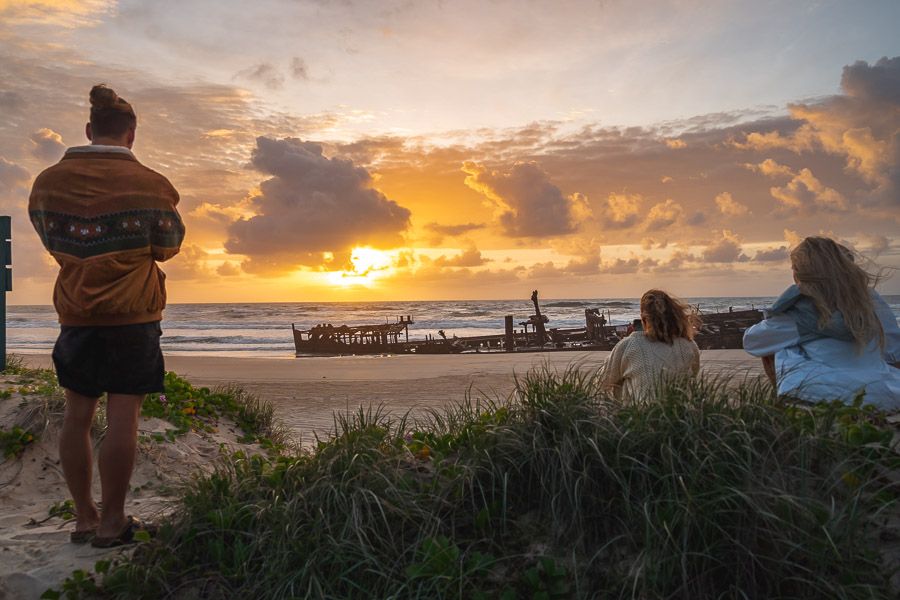 group of people watching sunset on fraser island