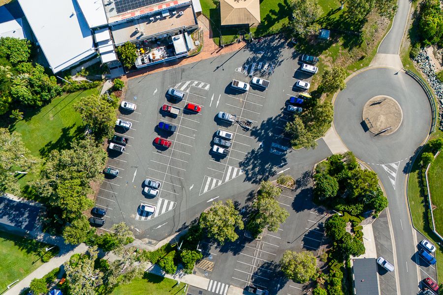 Airlie Beach sailing club parking lot with cars