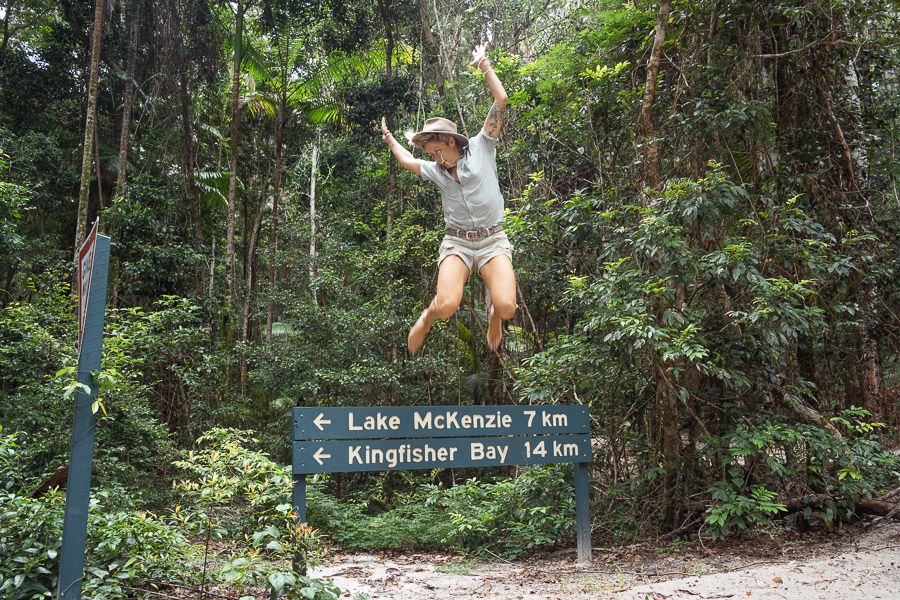 person jumping at a hiking trail on fraser island