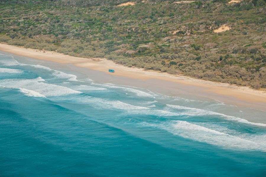 aerial view of a car driving up the coast