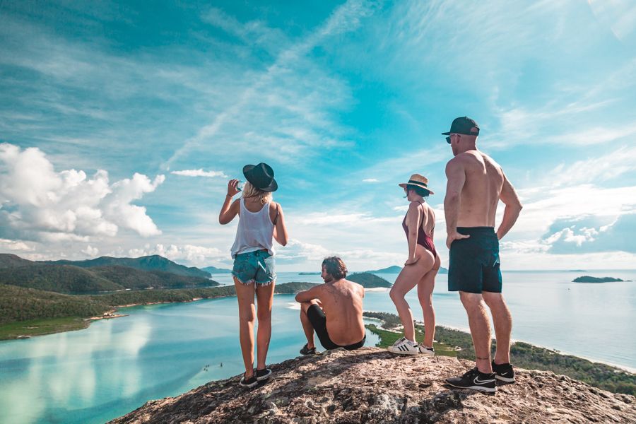 people overlooking the beach from a lookout