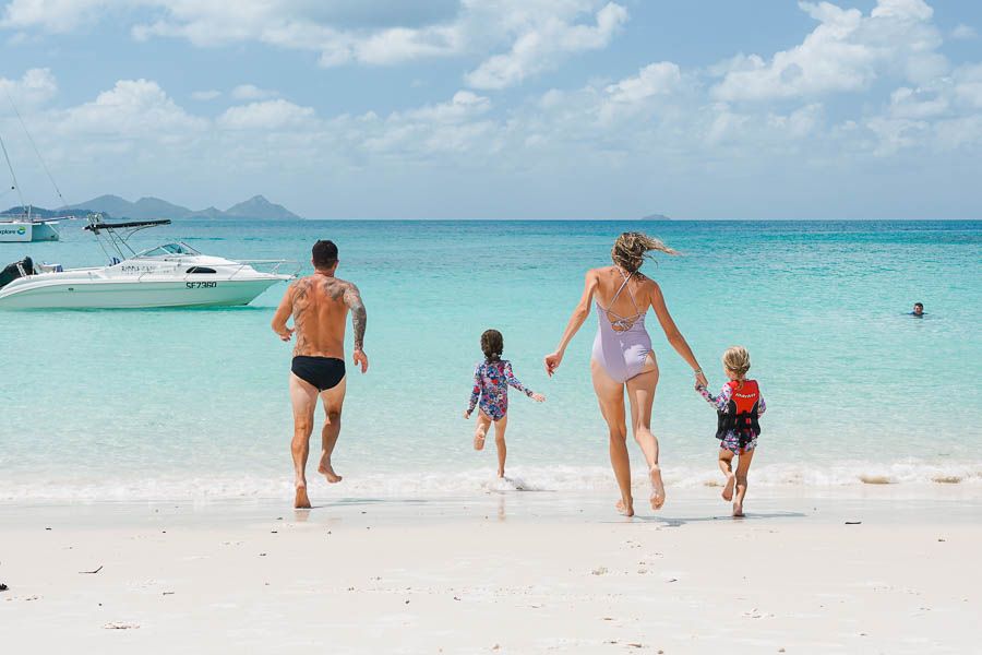 family running on the beach