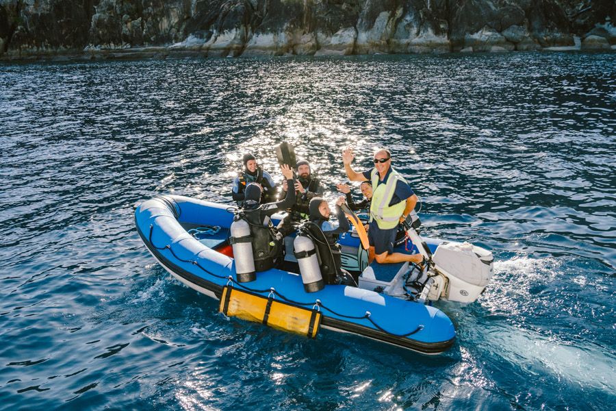 Group of divers heading to a dive spot in the Whitsundays with their guide