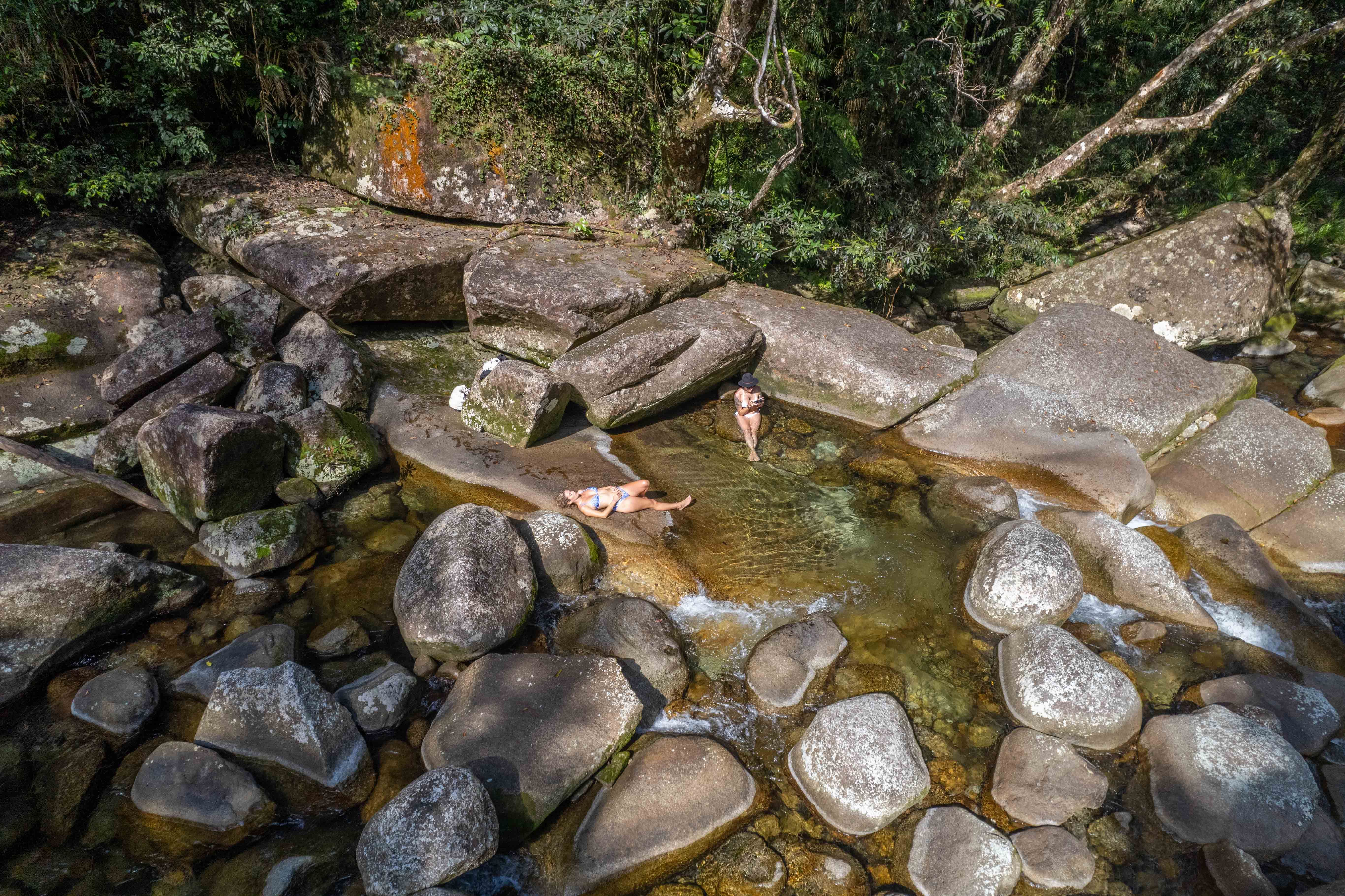 people floating in a natural rock pool