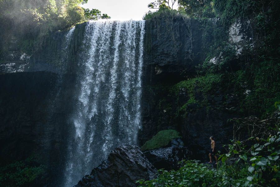 person standing near a waterfall