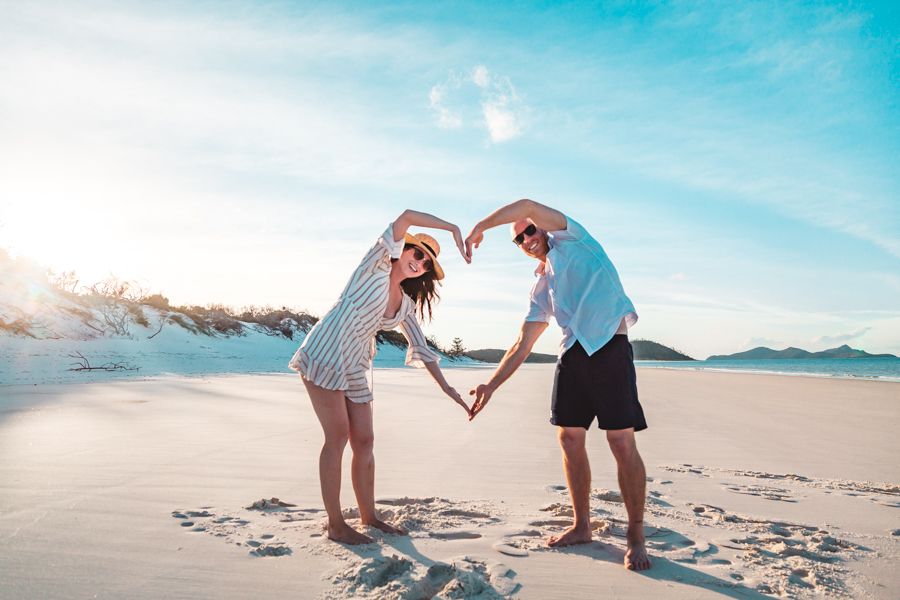 people making a heart with their arms