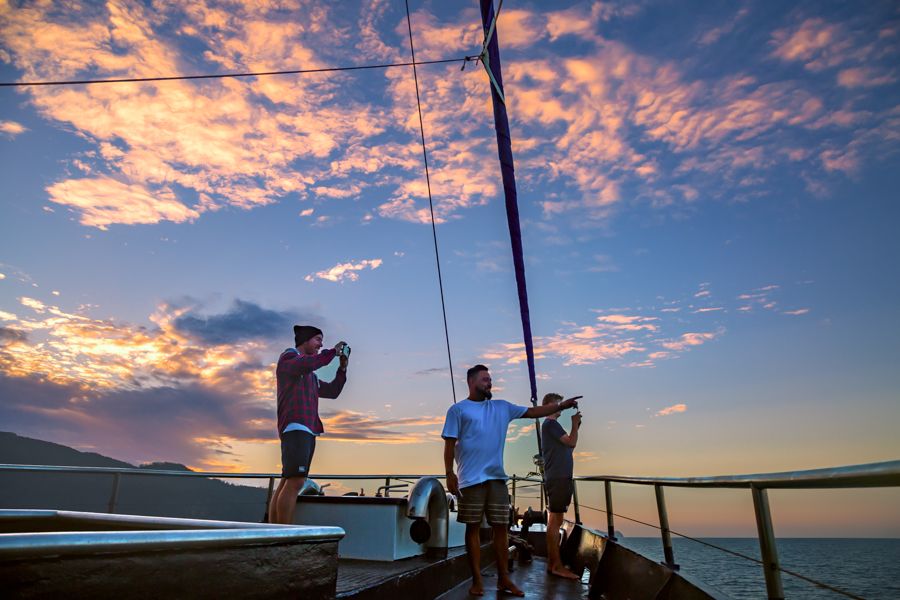 people on a boat at sunset