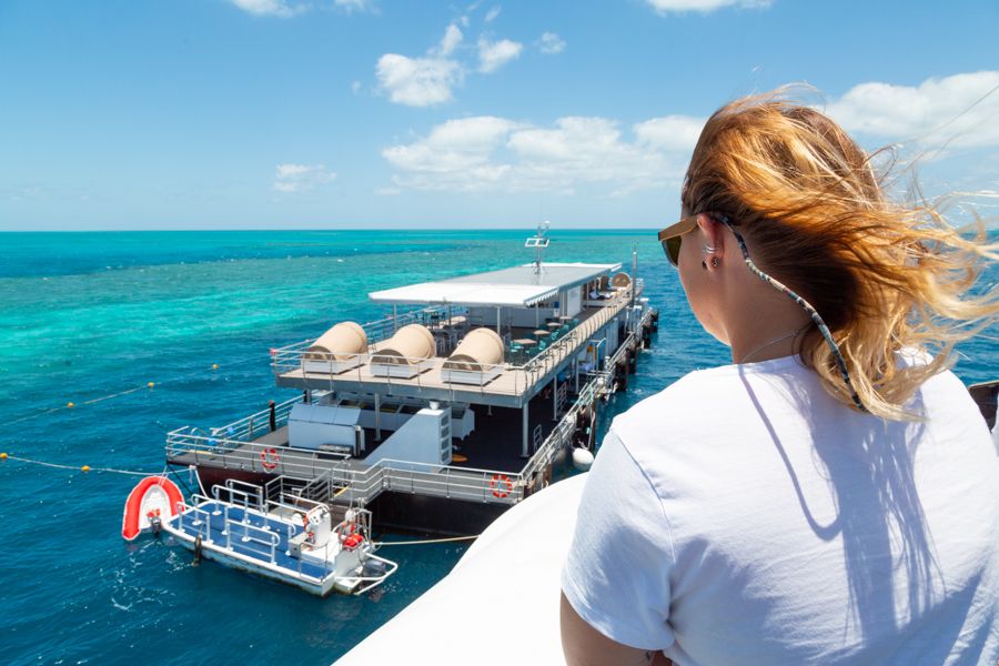 girl overlooking a great barrier reef pontoon in the Whitsundays