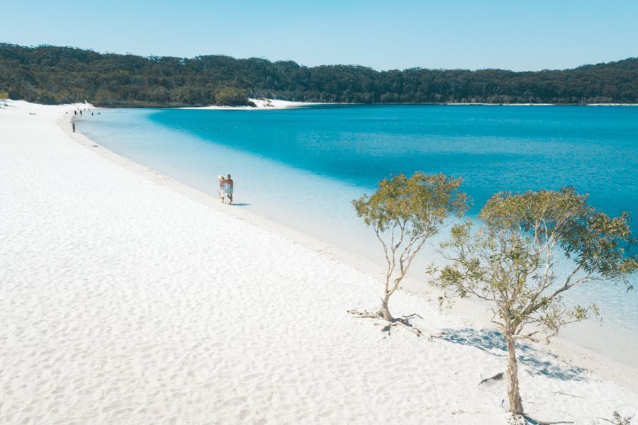 couple walking on the sand at Lake McKenzie, K'gari